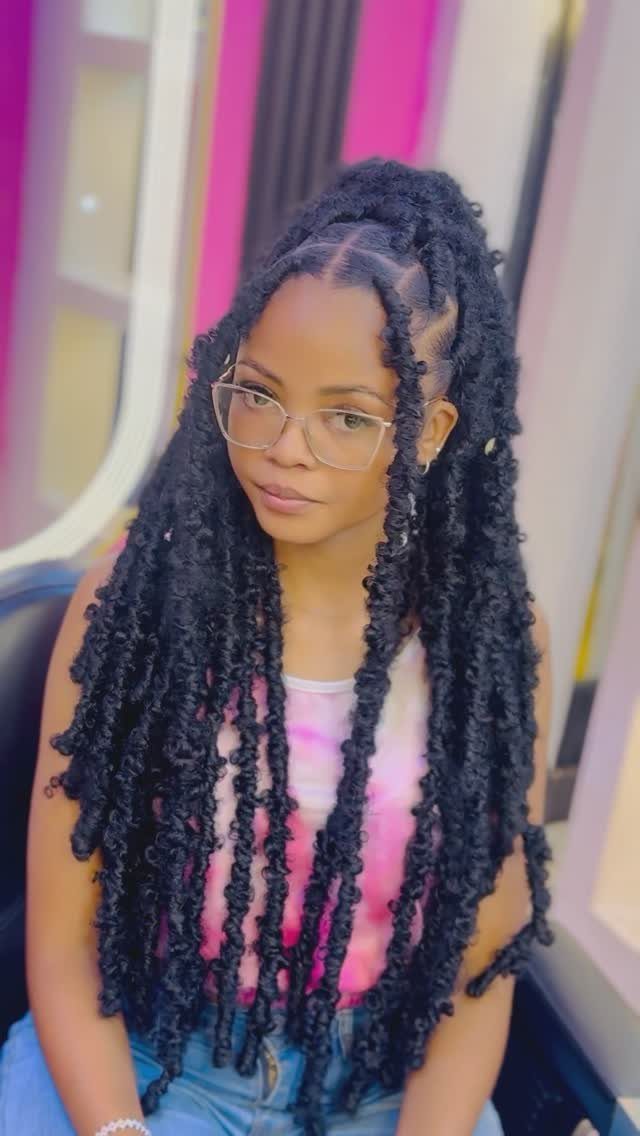 13 Trending Hair Style Ideas, from Curtain Bangs to Pixies 12 Woman with long black faux locs wearing glasses and a tie-dye shirt.