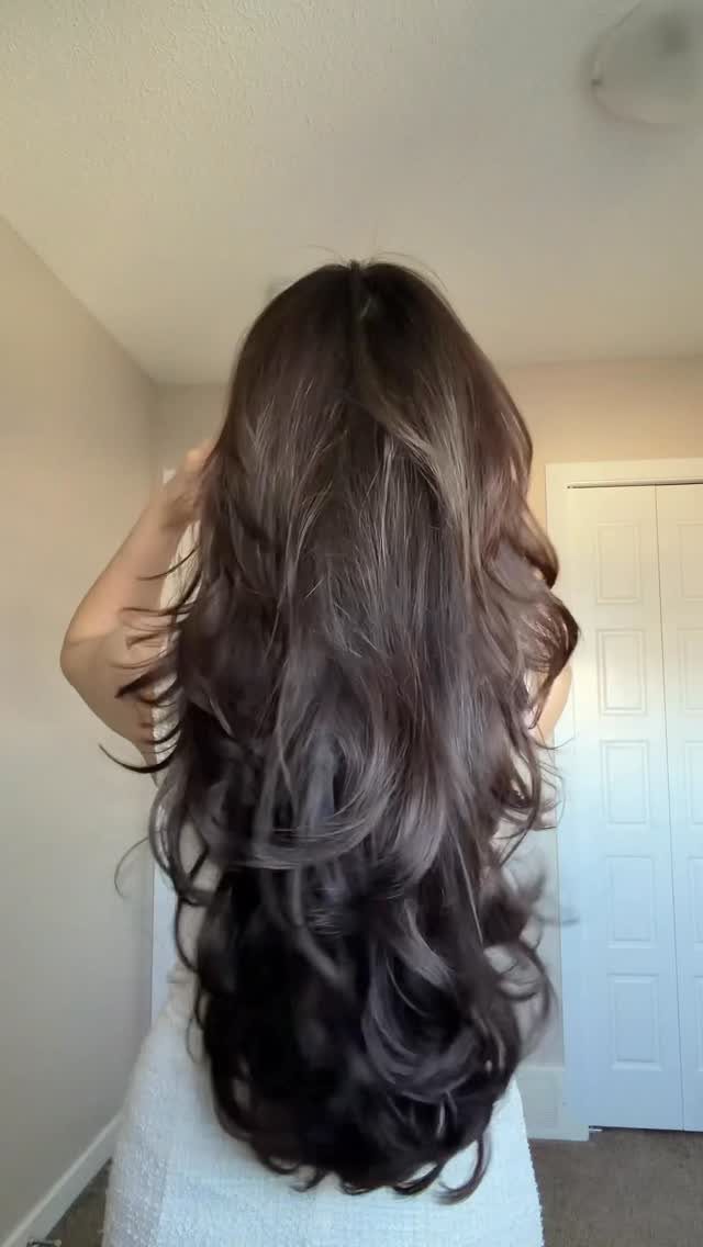 13 Trending Hair Style Ideas, from Curtain Bangs to Pixies 3 Long wavy brown hair with cascading layers seen from the back.