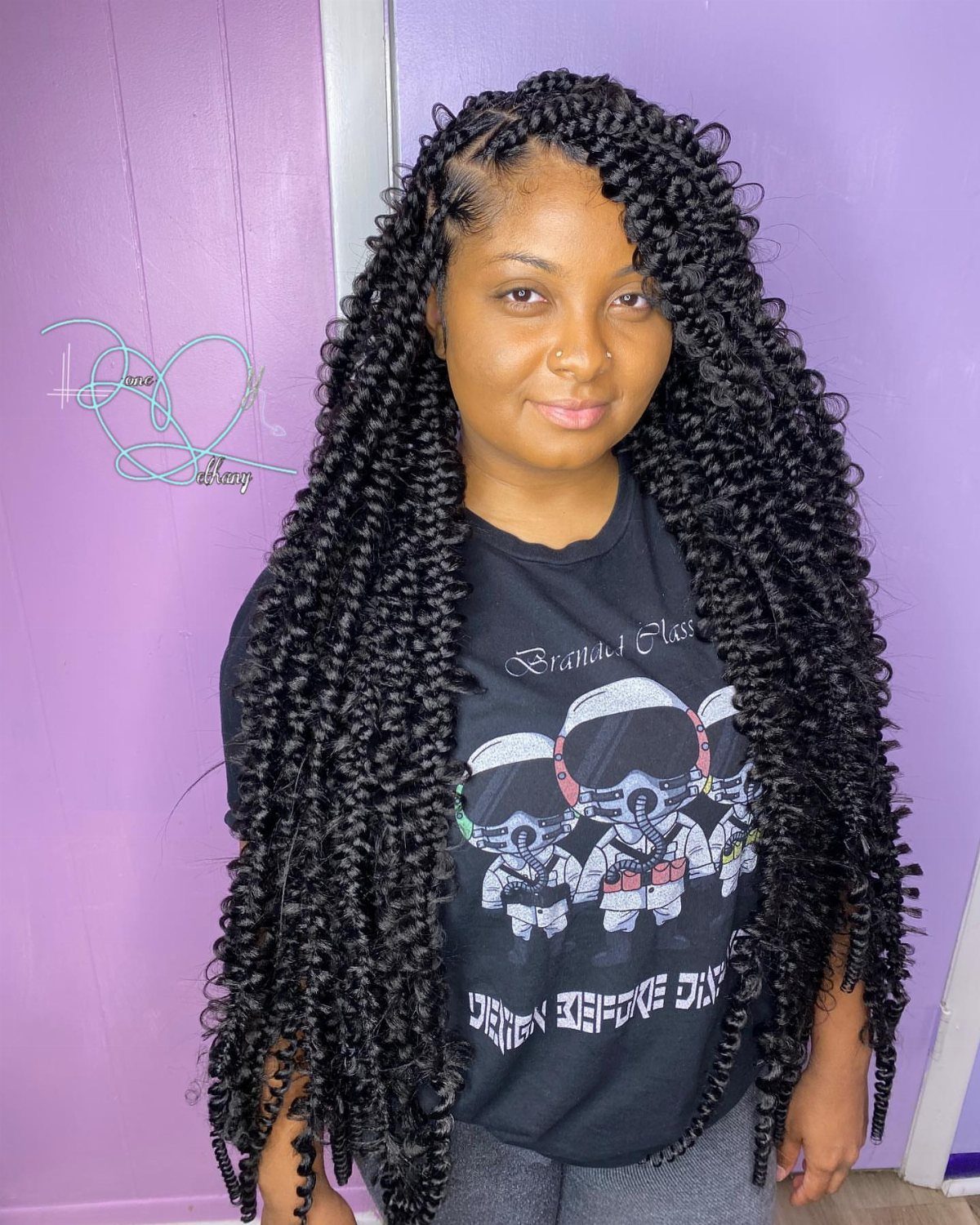 19 Tribal Braids with Boho Ideas, From Bobs to Buns 7 Woman with long black bohemian braids and curly ends against a purple background
