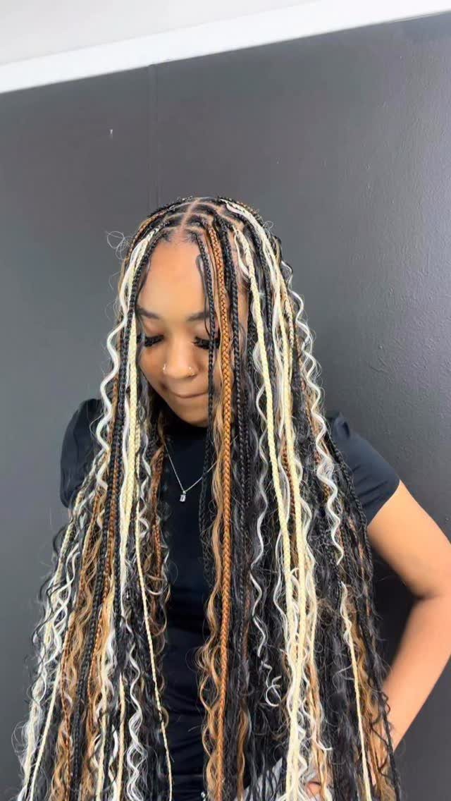 19 Tribal Braids with Boho Ideas, From Bobs to Buns 10 Woman with long blonde and brown boho knotless braids with curly ends.