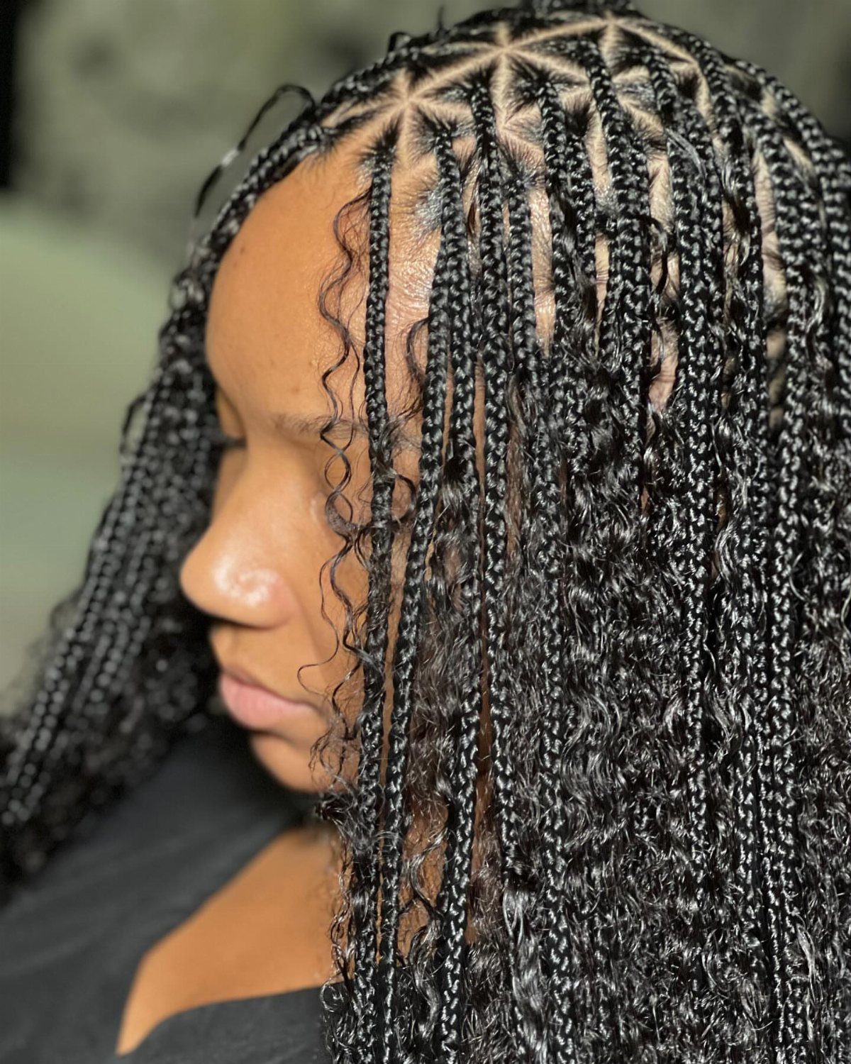 19 Tribal Braids with Boho Ideas, From Bobs to Buns 14 Woman with black bohemian braids styled in triangular scalp sections and curly ends.
