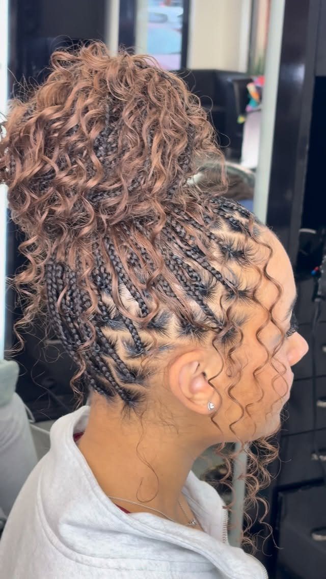 19 Tribal Braids with Boho Ideas, From Bobs to Buns 16 Person with tribal braids and a curly reddish-brown boho bun in a high ponytail.