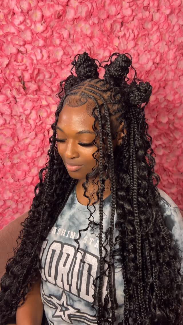 19 Tribal Braids with Boho Ideas, From Bobs to Buns 18 Woman with long black tribal braids and curly boho extensions against pink flowers