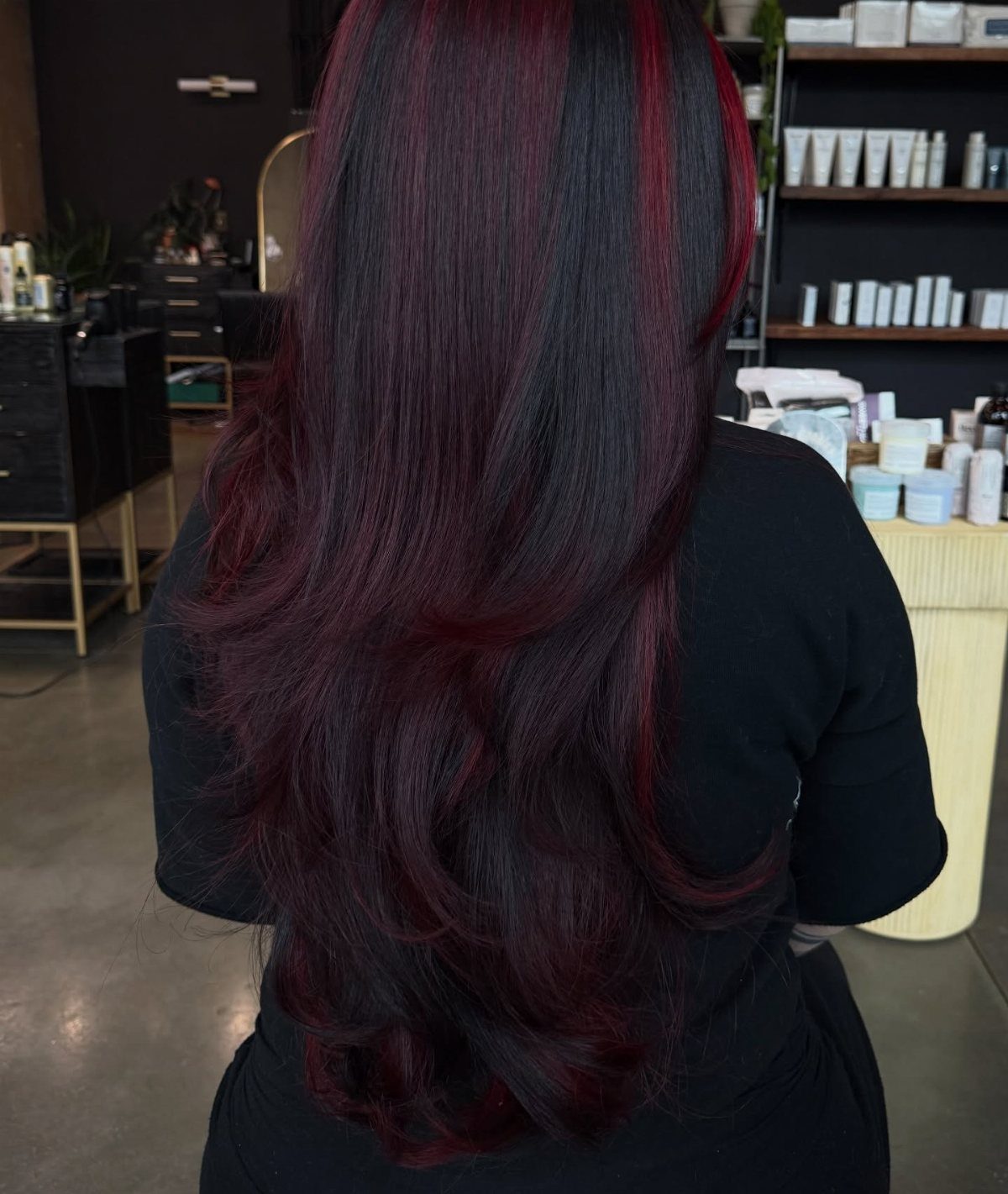 10 Violet Burgundy Hair Ideas for Dark to Bright Looks 8 Long wavy dark hair with deep burgundy and bright cherry red highlights.