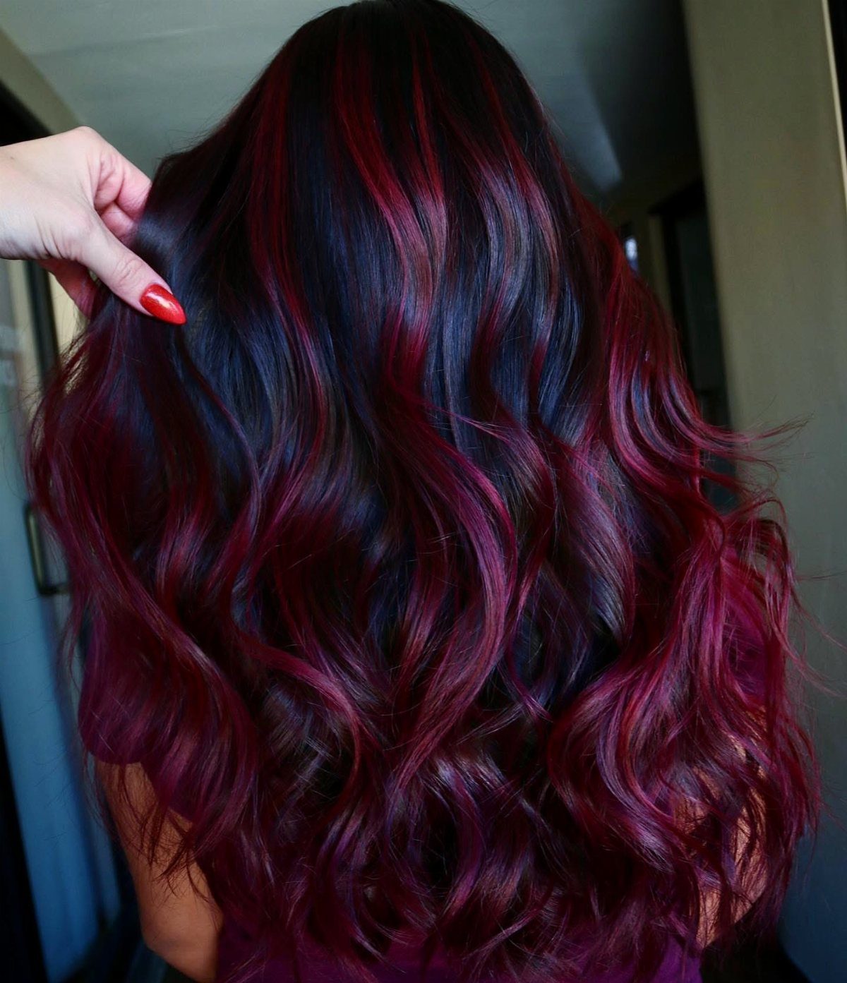 10 Violet Burgundy Hair Ideas for Dark to Bright Looks 7 Long wavy hair with deep burgundy and violet tones seen from behind.