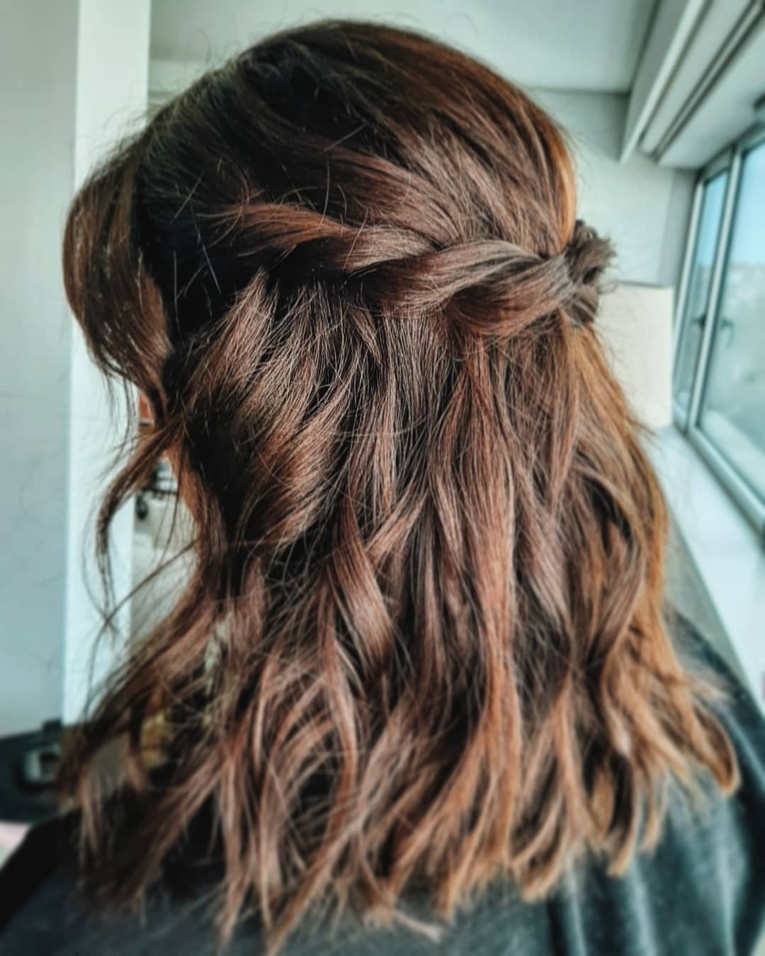 11 Wedding Guest Hairstyles for Medium Hair: Buns and Braids 5 Auburn medium hair styled in a twisted half-up look with loose waves