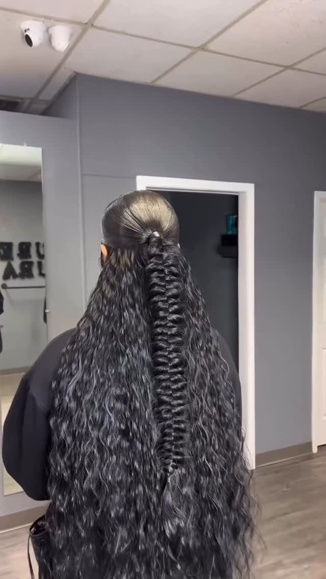 Y2K Braid Hairstyles: 9 Ideas From Butterfly Clips to Cornrows 9 Long curly black hair with a high half-up ponytail and center braid.