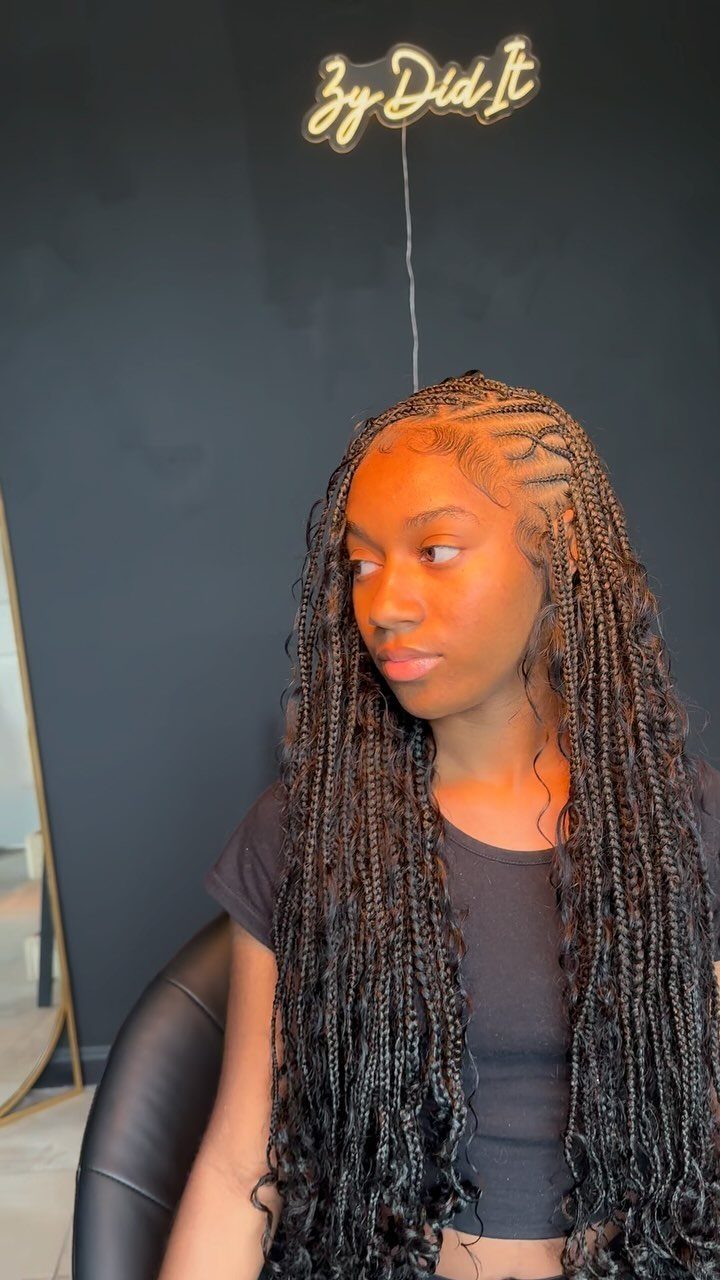 Y2K Braid Hairstyles: 9 Ideas From Butterfly Clips to Cornrows 8 Woman with long dark braids and intricate cornrow patterns on her scalp.